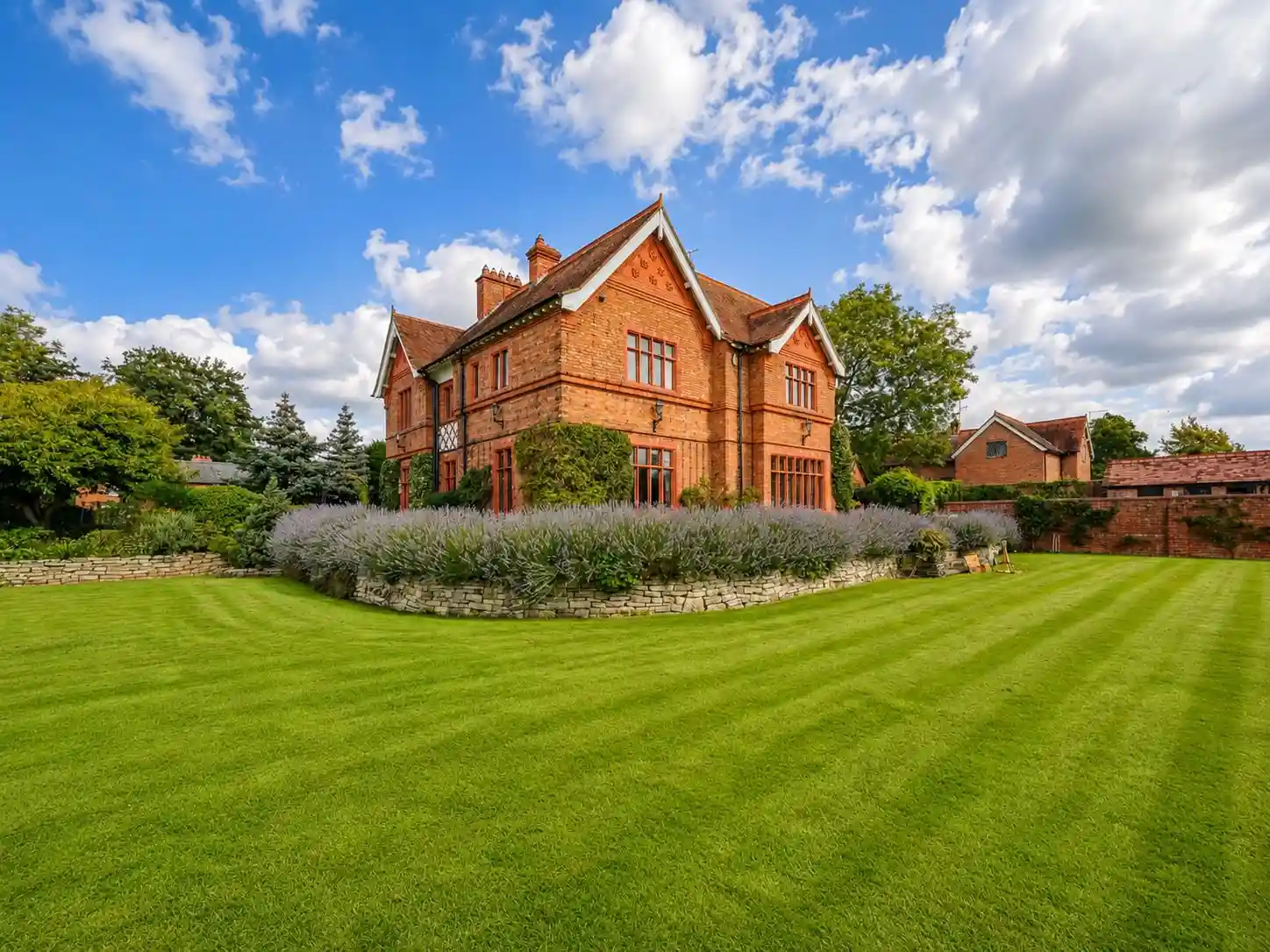 Landscaped cottage gardens and lawns in the grounds of The Old Rectory